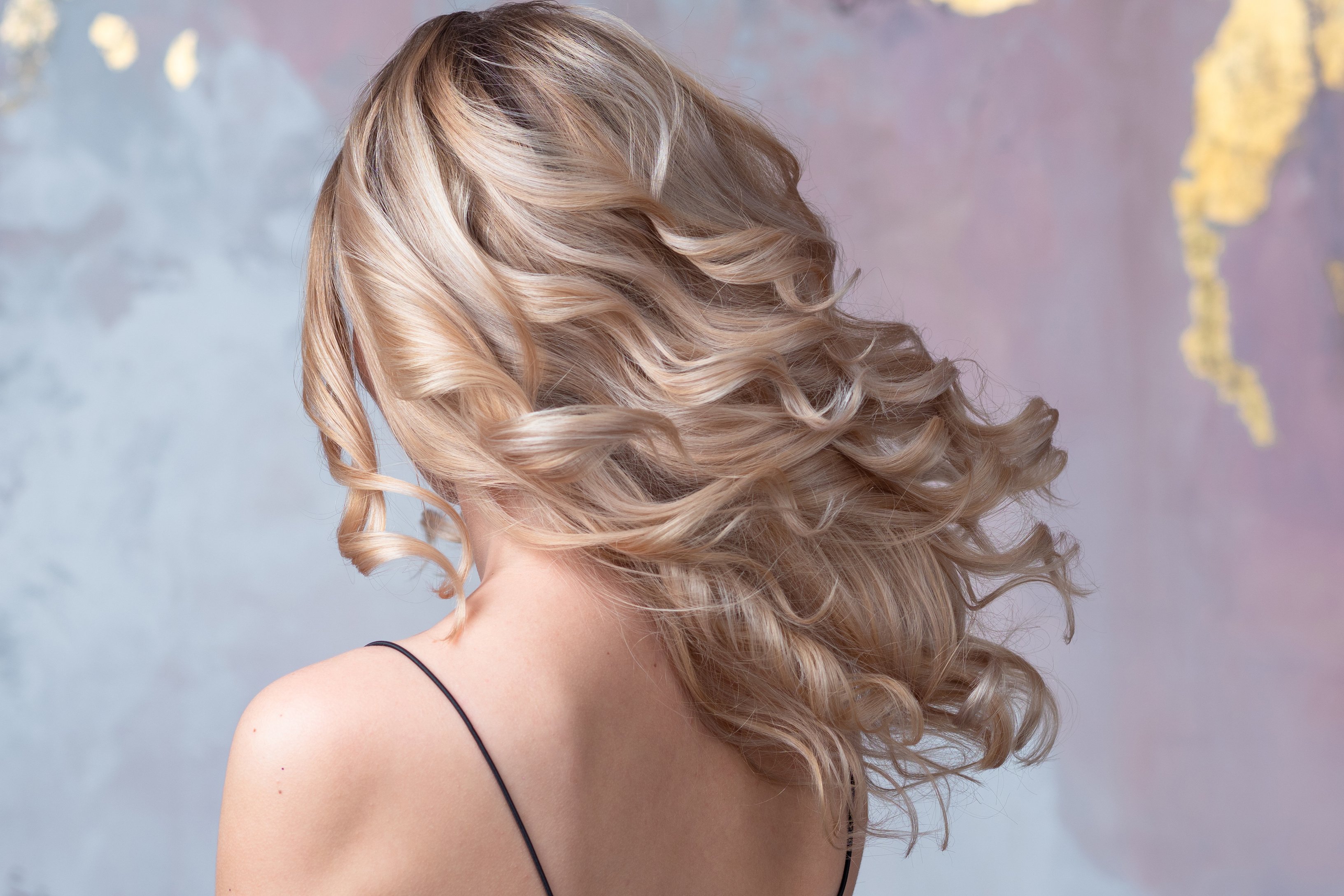 Perfect blonde, beautiful and well-groomed blonde hair. Long curls,